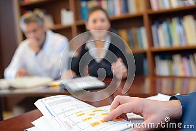 Closeup hand pointing to booklet at conference Stock Photo