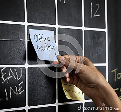 Closeup of hand pulling sticky note Stock Photo