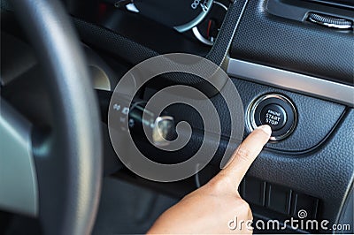 Closeup hand pushing on car engine start Stock Photo