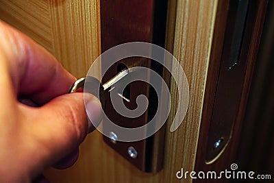 Closeup of a hand unlocking the door with the key Stock Photo