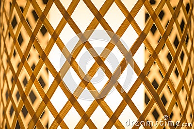 Closeup hand-woven bamboo table lamp with warm and cozy light. Stock Photo