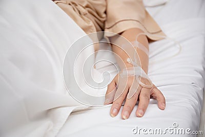 Closeup hands asian elderly woman asleep with surveillance in hospital ward, patient senior unconscious lying. Stock Photo