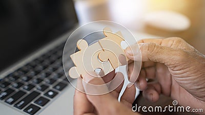 Closeup of hands connecting jigsaws find best business solution or option. Businessman connect pieces of puzzle think of problem Stock Photo