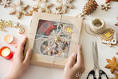 Closeup of hands holding a festive box with Christmas cookies Stock Photo