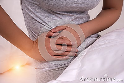 Closeup the hands holding on stomachThe stomach pain disease Stock Photo