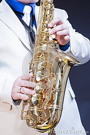 Closeup of Hands of Male Saxophone Player Posing With Sax Stock Photo