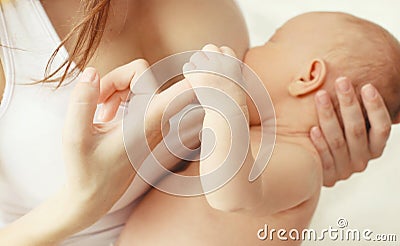 Closeup hands, mother feeding breast baby Stock Photo