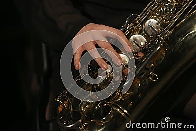 Closeup of Musician Playing Baritone Saxophone Stock Photo