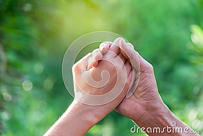 Closeup hands of people shaking up about winner on nature background Stock Photo