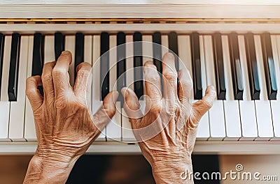 Closeup of hands playing the piano, white background, natural light, soft tones, indoor environ Stock Photo