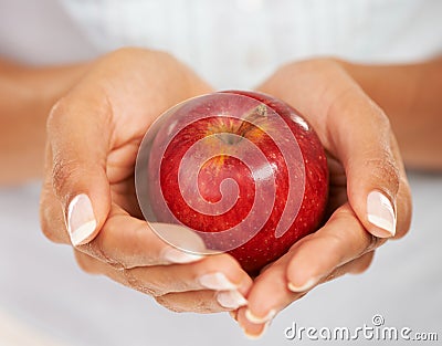 Closeup, hands and woman with a red apple, nutrition and healthy snack with diet plan. Person, home and girl with a Stock Photo