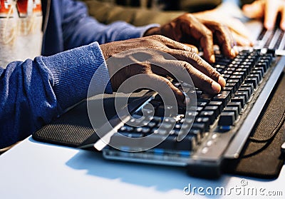 Closeup of hands working on computer keyboard Stock Photo