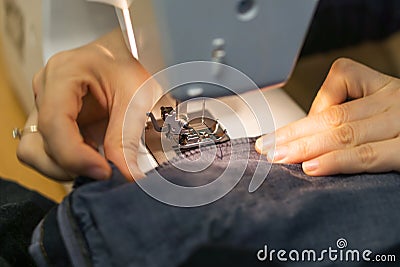 Closeup, of hands a yong woman on the sewing machine, stitching t Stock Photo