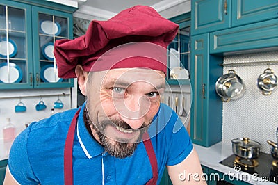 Closeup of Handsome chef in hat with smile to you. Man in apron at kitchen. Portrait of happy chef Stock Photo