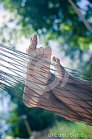 Closeup of happy family lying on hammock on sunny countryside background. Stock Photo