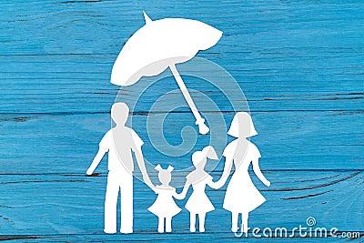 Closeup of happy paper family on blue background Stock Photo