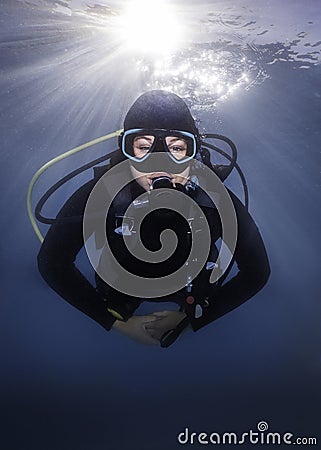 Closeup of a happy scuba diver underwater facing the camera Stock Photo