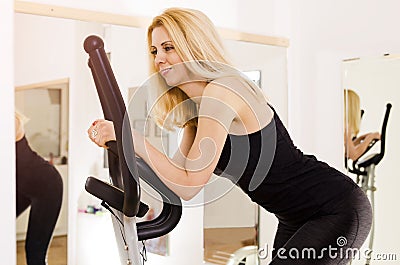 Closeup, happy woman on ellipse trainer Stock Photo