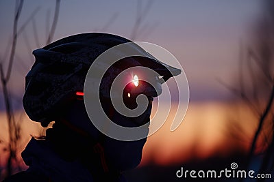 closeup of headlamp on helmet during twilight Stock Photo