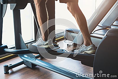 closeup healthy fitness people man sport strength exercise activity at gym on eclipse climbs machine Stock Photo