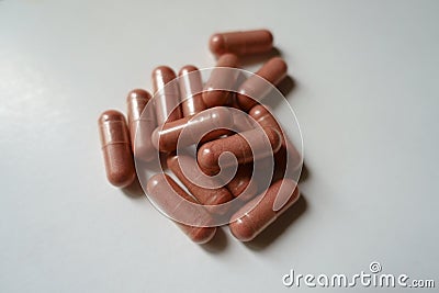 Closeup of heap of pink capsules of PQQ dietary supplement Stock Photo