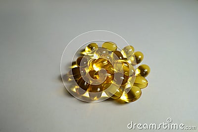 Closeup of heap of yellow softgel capsules of vitamin A retinyl palmitate Stock Photo