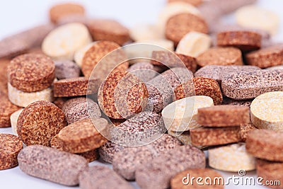 Closeup of herbal vitamin and supplement pills with herbs. Stock Photo