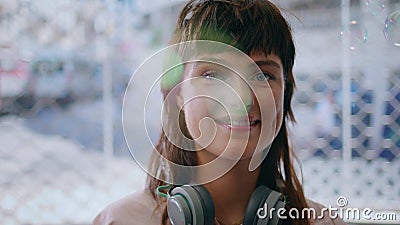 Closeup hipster girl posing in air soap bubbles. Smiling teenager with stylish Stock Photo