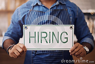 Closeup, hiring sign and man advertising employment in shop, store and notice of recruitment opportunity. Hands, banner Stock Photo