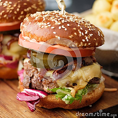 Closeup of Homemade delicious juicy burger with beef, cheese, to Stock Photo