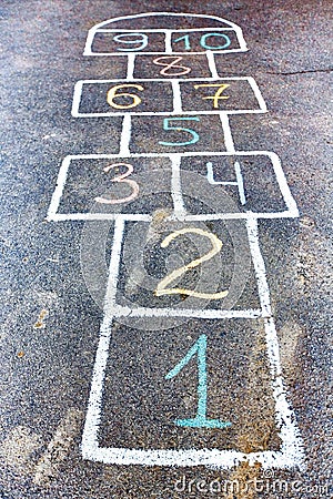 Closeup of hopscotch drawn with chalk on asphalt road. Children Stock Photo