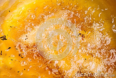 Closeup of hot bubbling boiling oil in a deep fryer Stock Photo