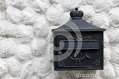 Closeup house facade black ornate wrought mailbox Stock Photo