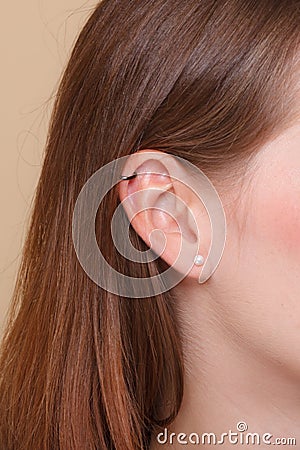 Closeup human ear with earrings Stock Photo