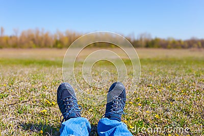 Closeup human feet lie on a grass Stock Photo