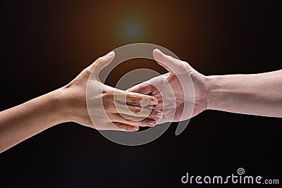 Closeup human hand ,between mand and woman.they are reaching to touch together,the sign and symbol of friendship Stock Photo