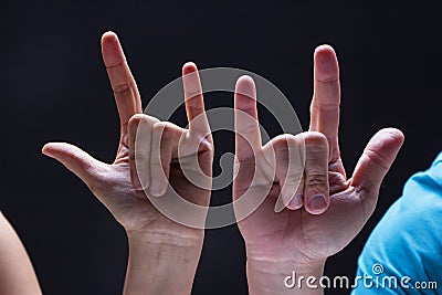 Closeup human hands in Rock and Roll sign and symbol Stock Photo