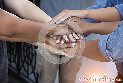 Closeup human hands stacked together,cooperation concept Stock Photo