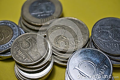 Closeup Hungarian Forint FT HUF coins stacked up in a pile laying on green background Stock Photo