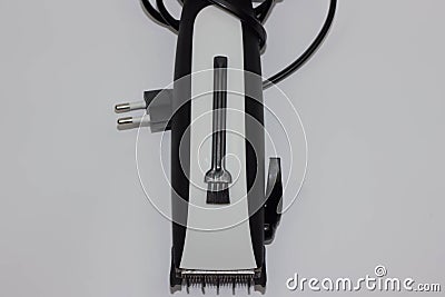 Closeup image of arm holding hairclipper, on white background, an electric hair clipper in hand for hairdressers Stock Photo