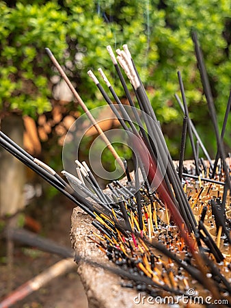 Closeup photo of burning incenses in the buddhist temple garden Stock Photo