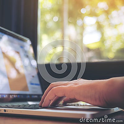 Closeup image of a business woman`s hands working , touching and typing on laptop keyboard Stock Photo