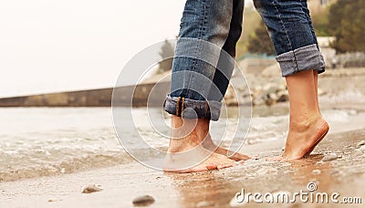 Closeup image couple legs at the beach Stock Photo