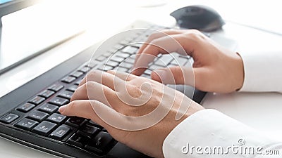 Closeup photo of slim female hands typing text on computer keyboard Stock Photo