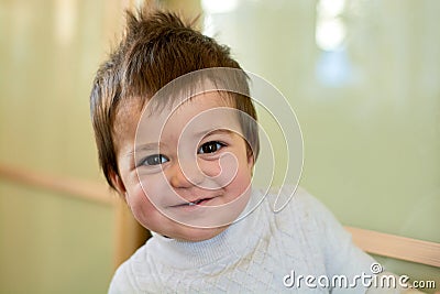 Closeup indoor portrait of a baby boy with naughty hair. The various emotions of a child. Stock Photo