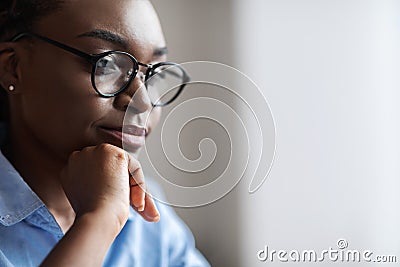 Closeup Indoor Portrait Of Black Female Business Analyst In Eyeglasses, Side View Stock Photo