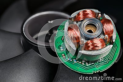 Closeup of inductors on stator and rotor with permanent magnet and black blades in background Stock Photo