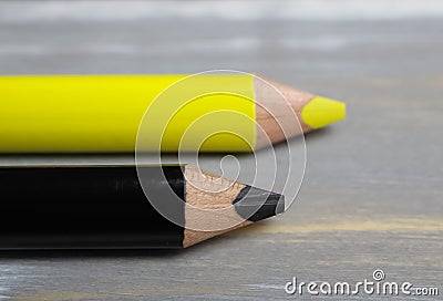 Closeup of isolated colorful yellow and black crayons on wood background - german parties FDP and CDU coalition concept Stock Photo