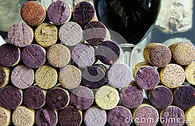 Closeup of isolated stack many red wine corks with glass background focus on center of left pile part Stock Photo