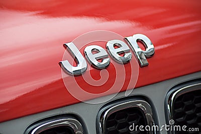 Closeup of jeep logo in orange front car parked in the street Editorial Stock Photo